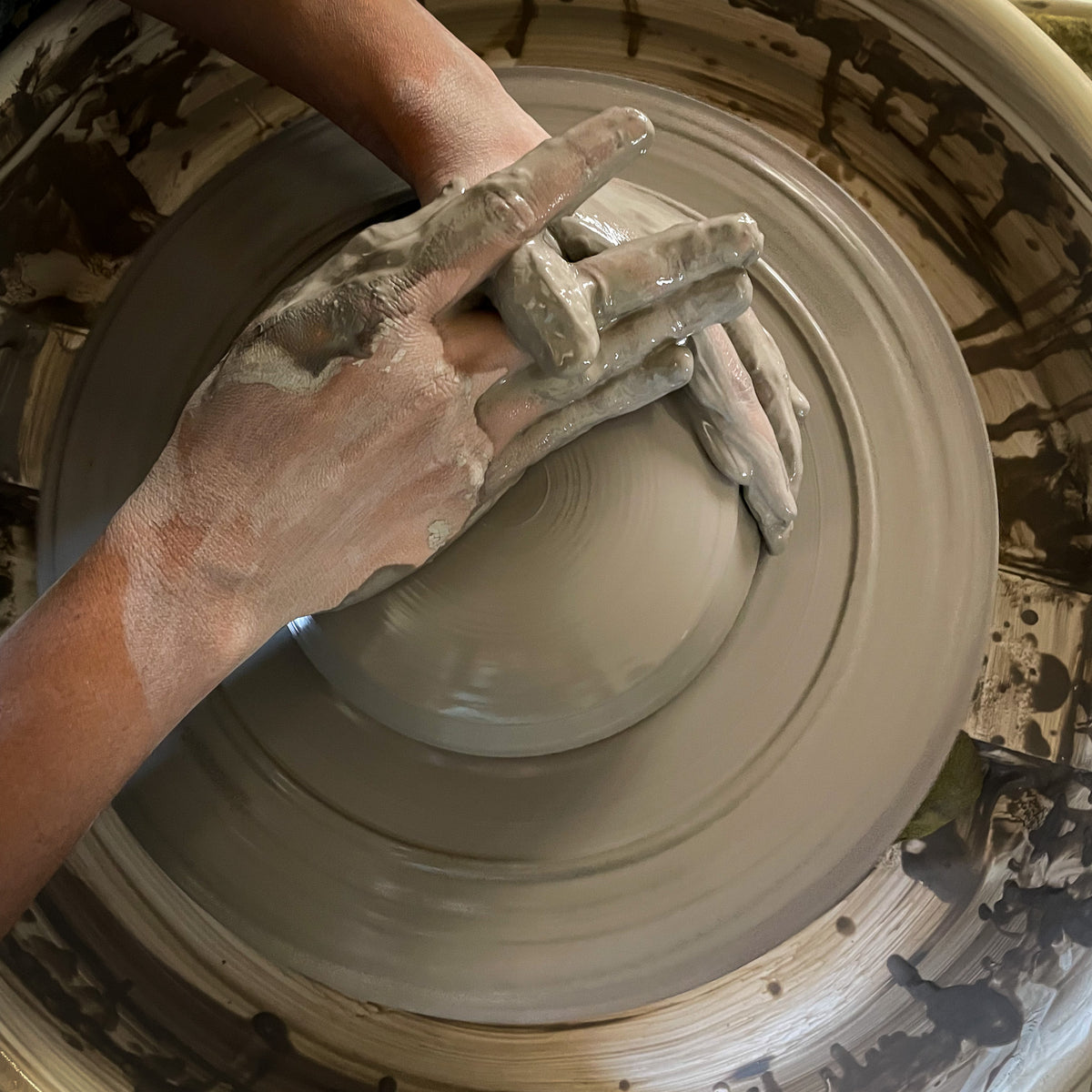 centering clay on pottery wheel