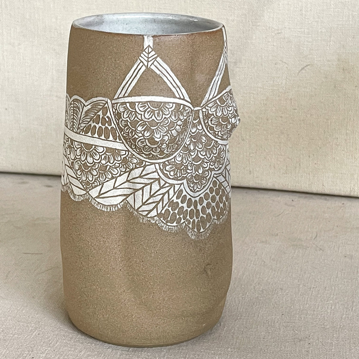Brunnhilde Vase from Déesses de la nuit collection. Brown Body Stoneware Vase in the shape of the female form with sgraffito lacework done with white slip. Profile view